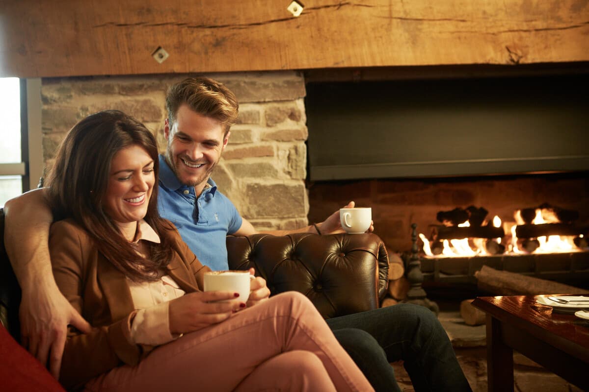 Rafters Restaurant - Couple Enjoying Coffee by the Fireplace
